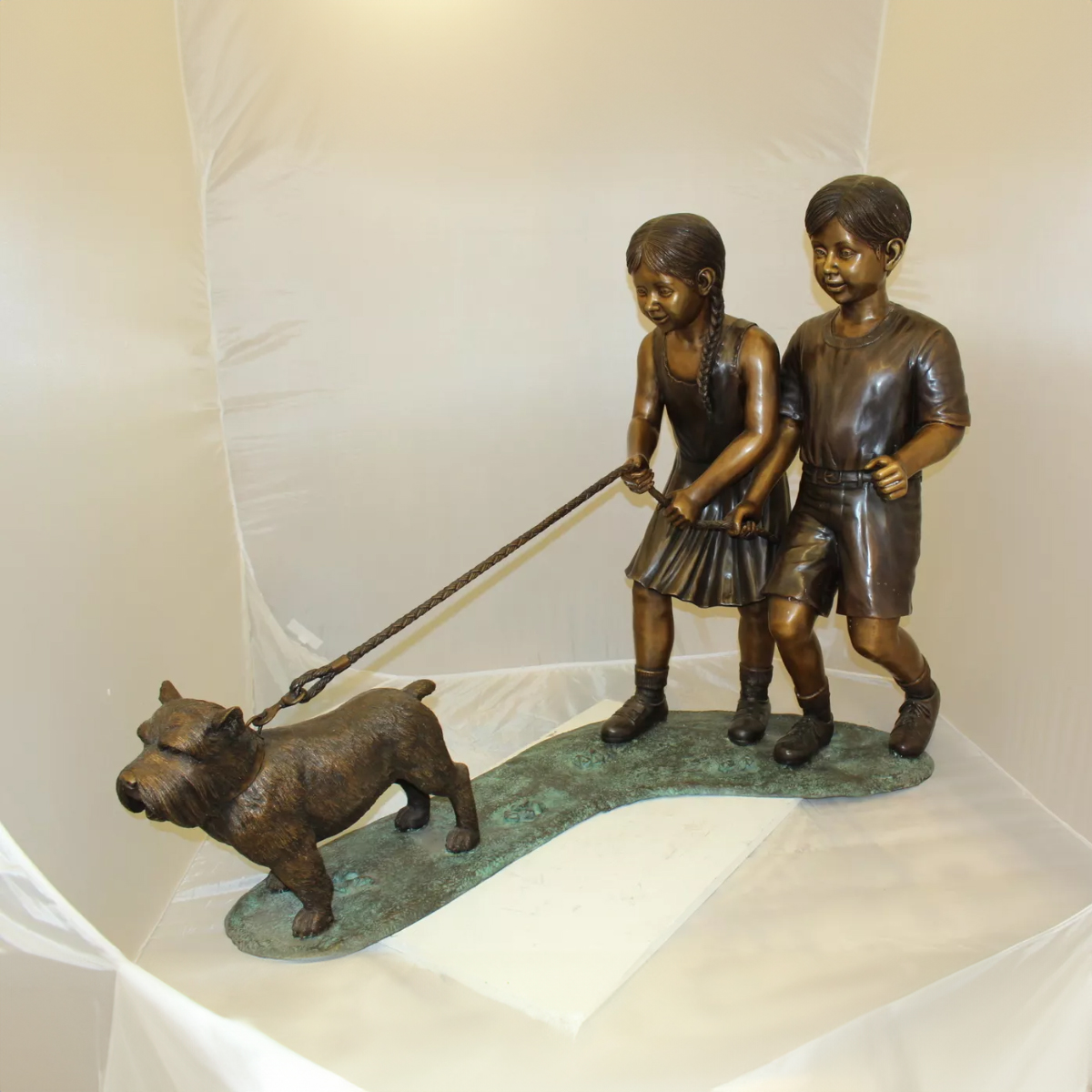 Bronze Children Walking Dog