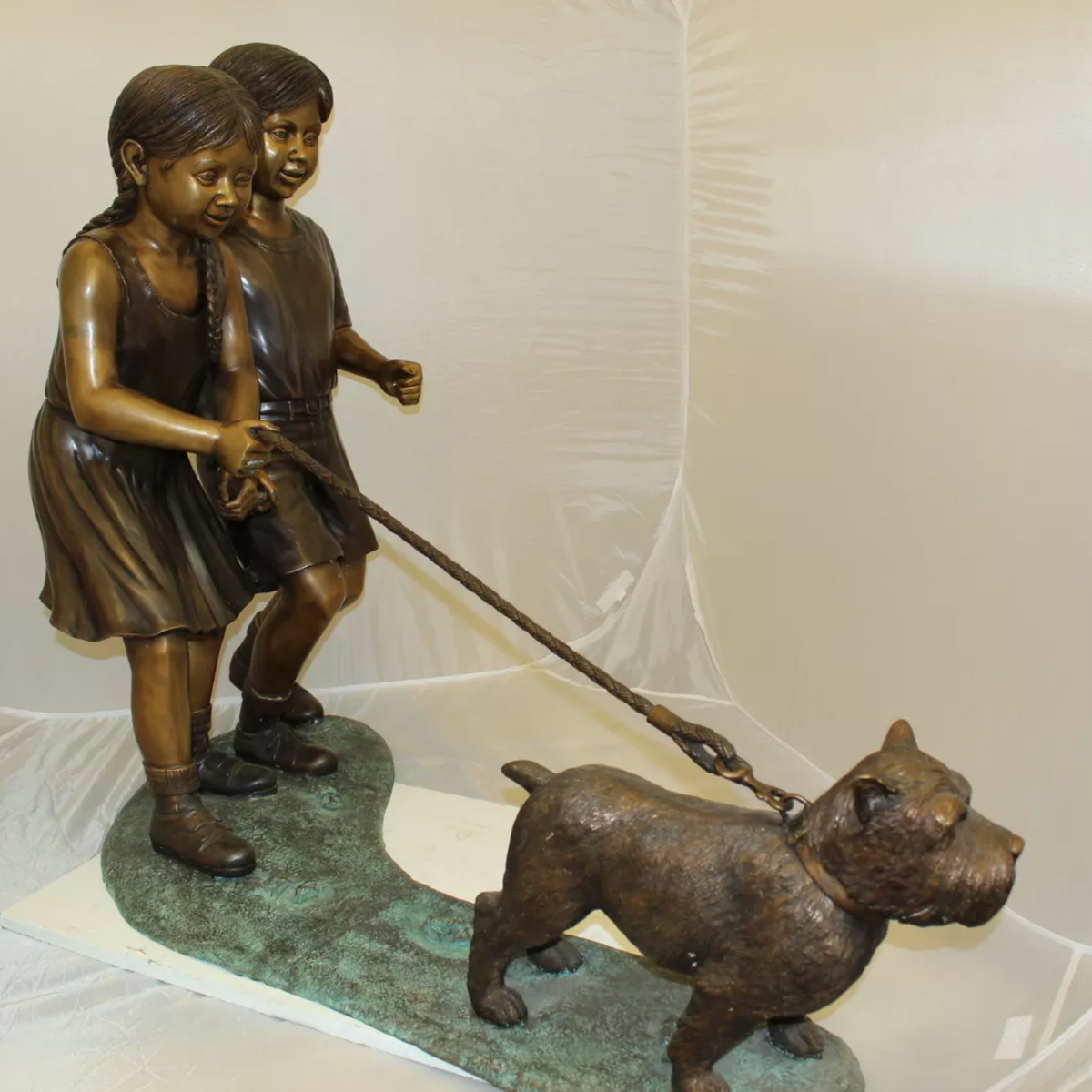 Bronze Children Walking Dog