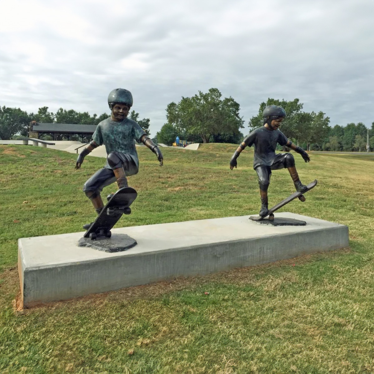 Children Playing on Skateboard Statue