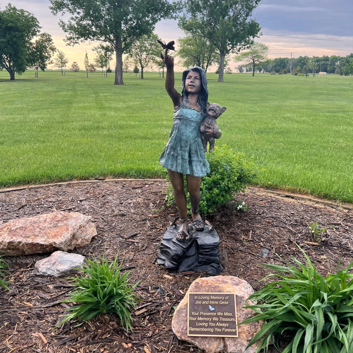 Girl Holding Dog with Butterfly Statue