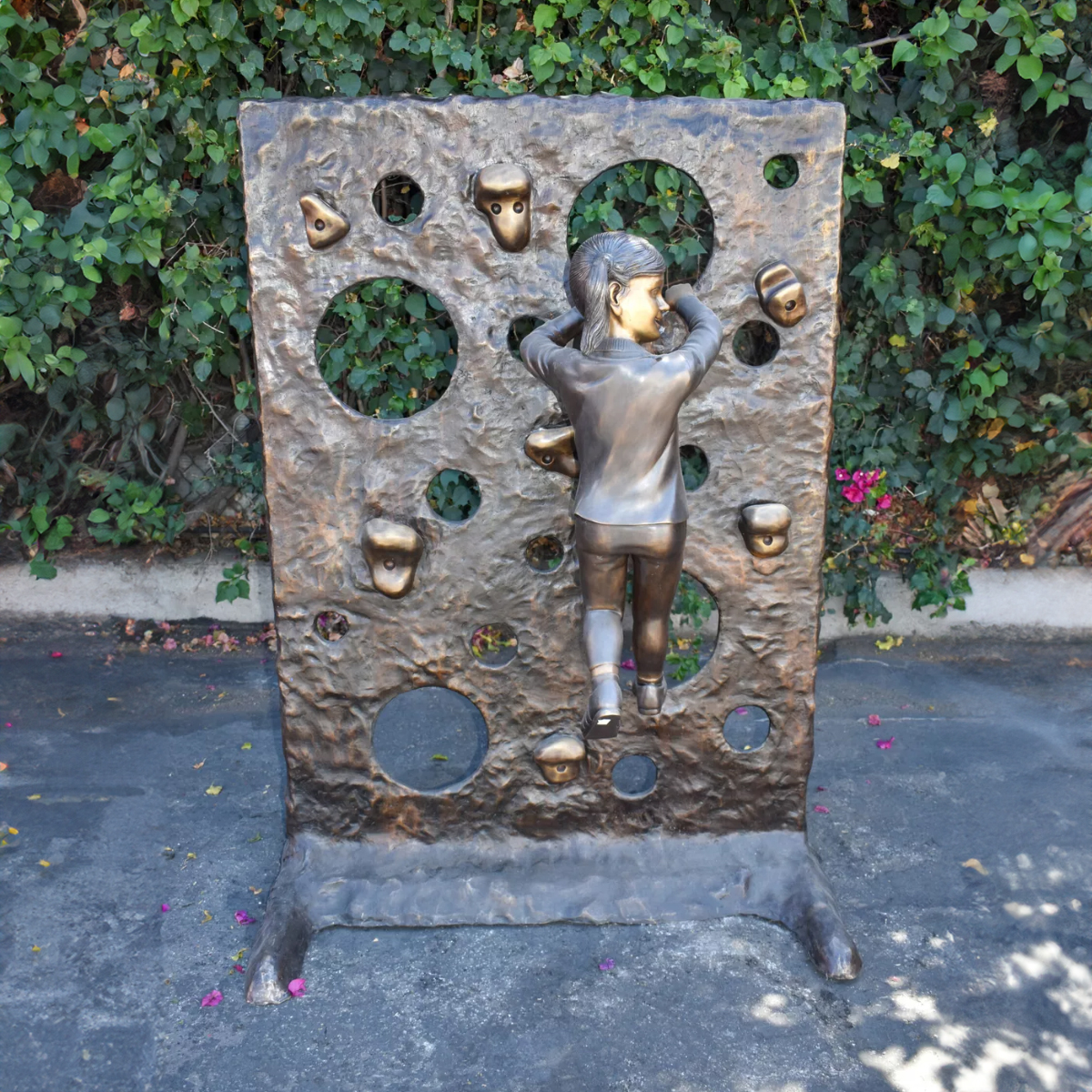 Girl on Climbing Wall Statue