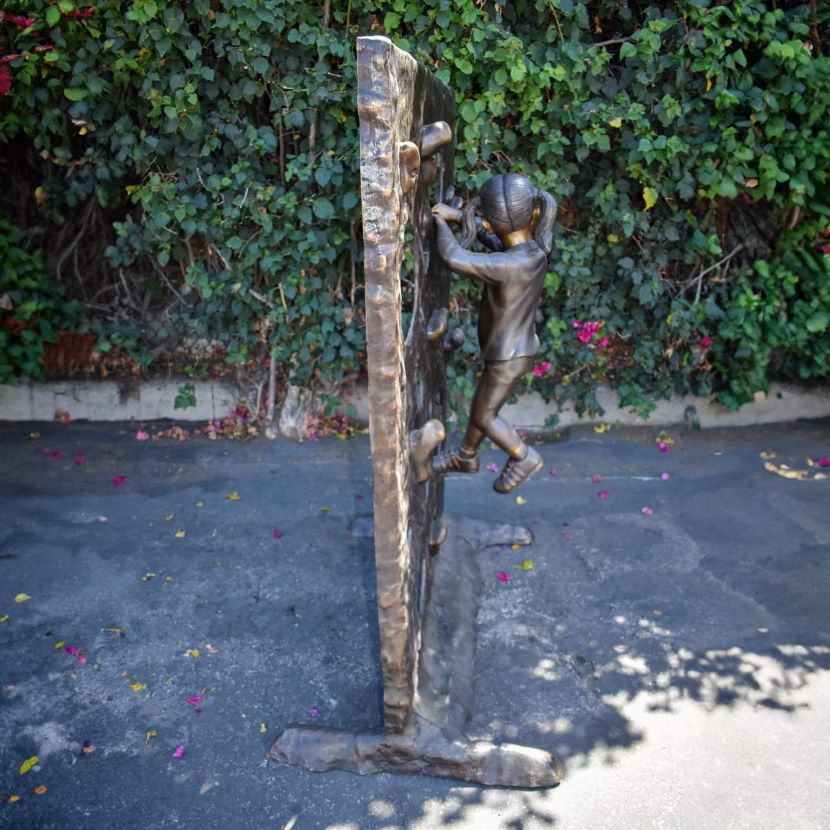 Girl on Climbing Wall Statue