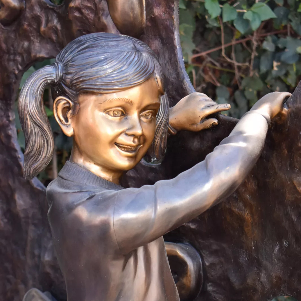 Girl on Climbing Wall Statue