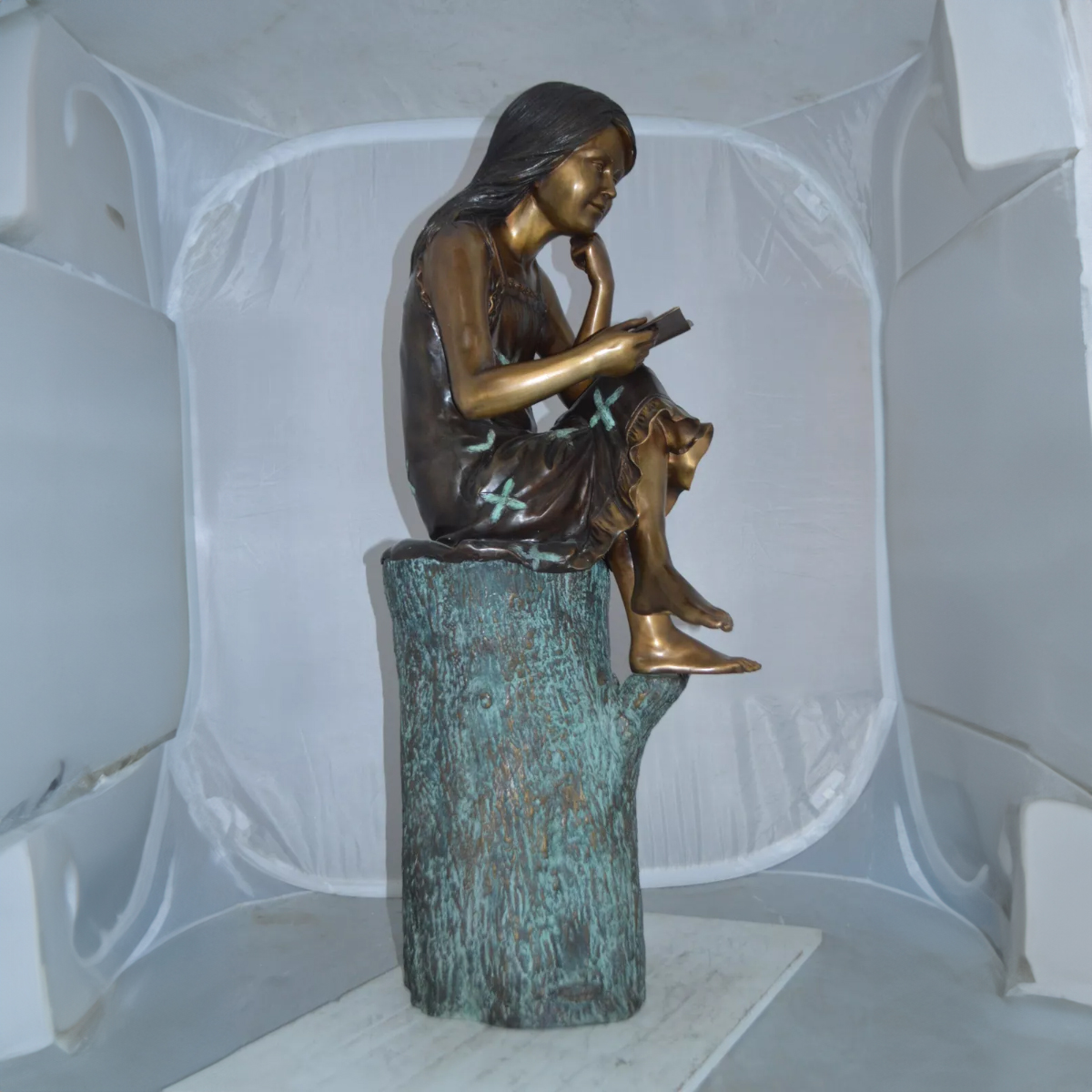 Girl on Log Reading Statue