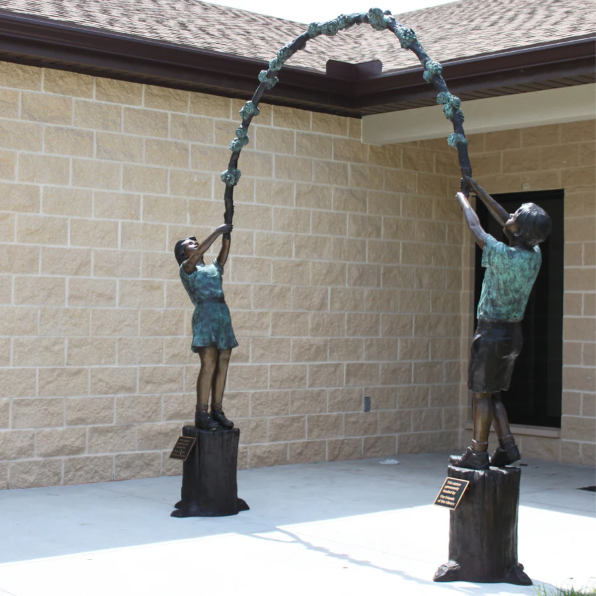 Kids Holding Floral Arbor Statue