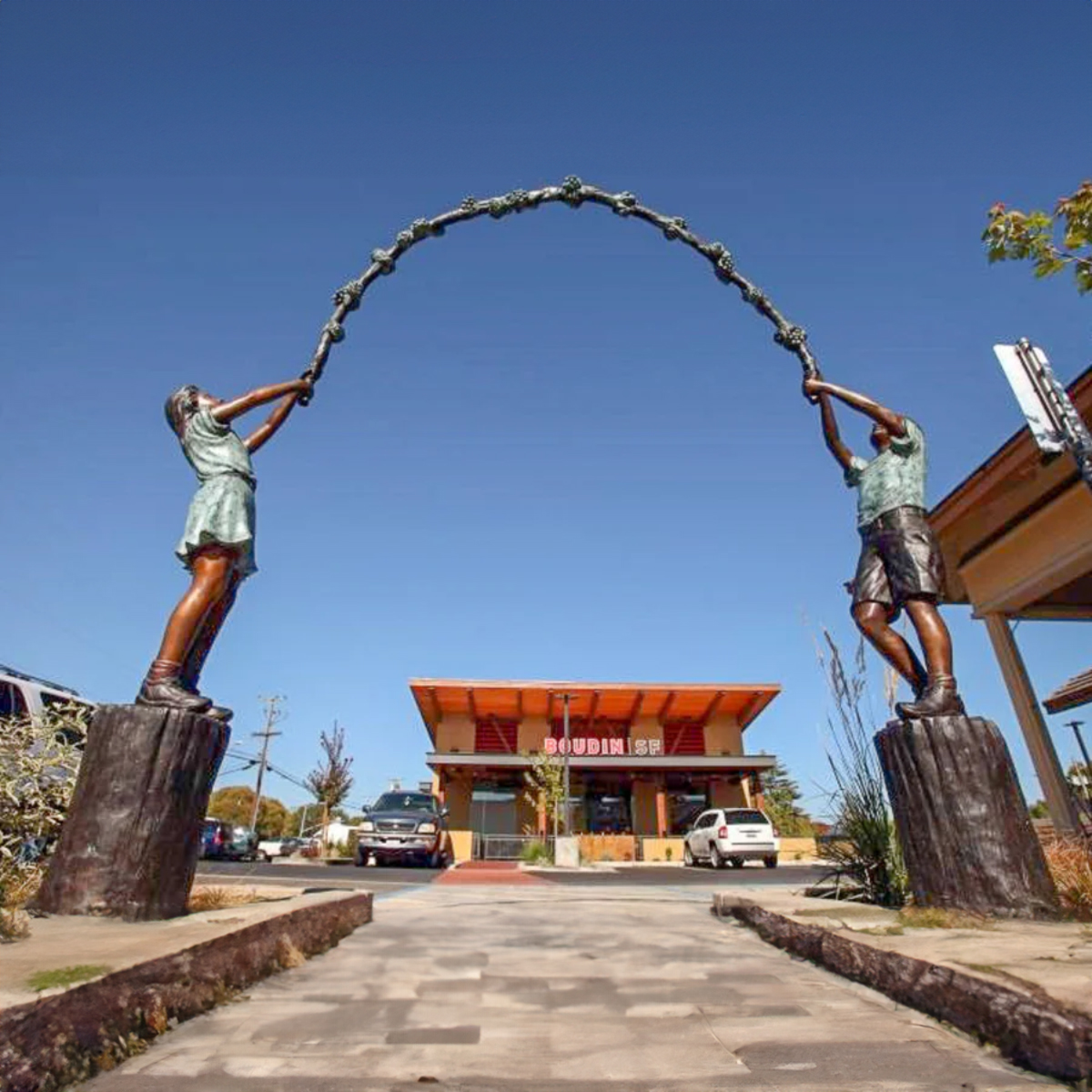 Kids Holding Floral Arbor Statue