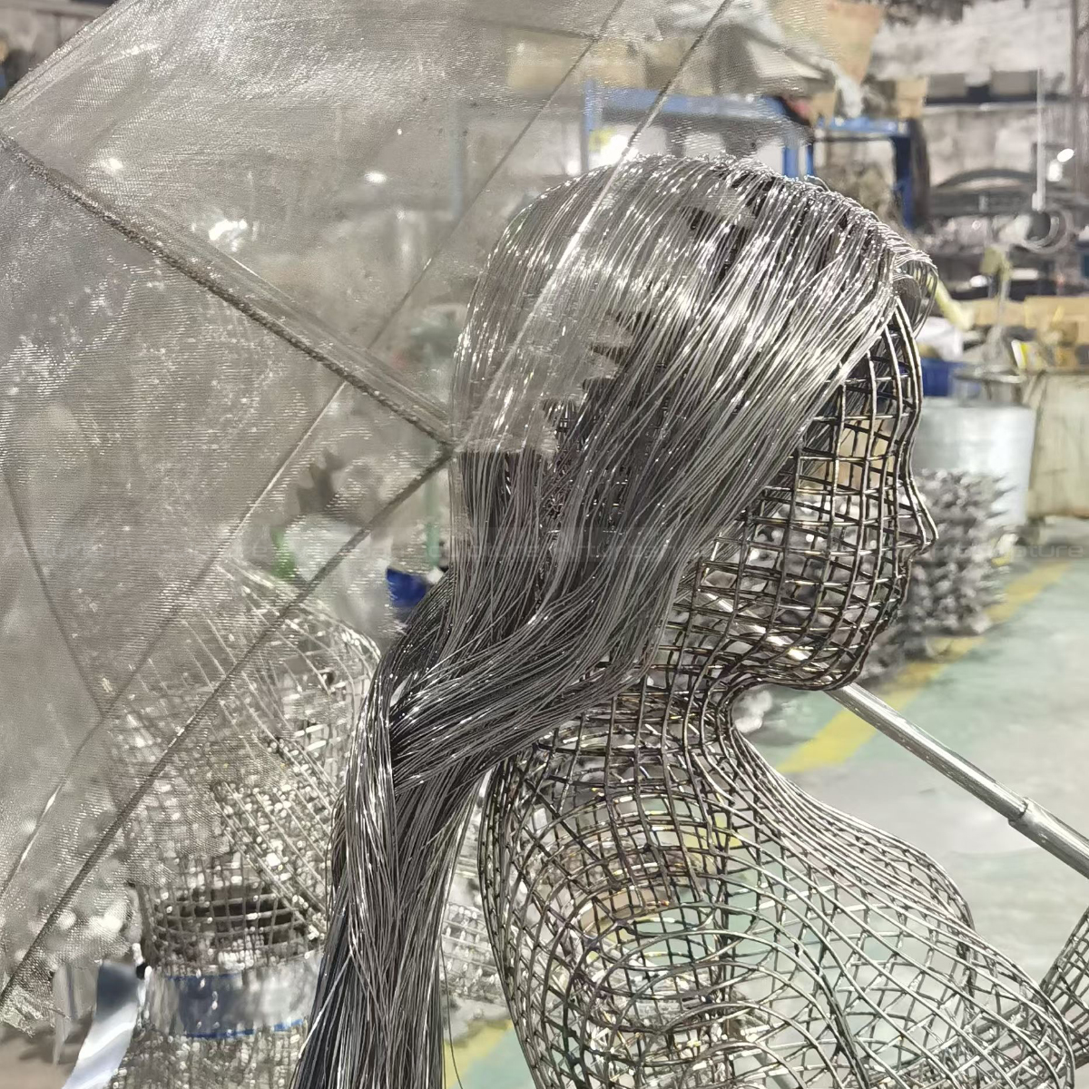 Close-up of Figurative Wire Sculpture, a woman holding an umbrella