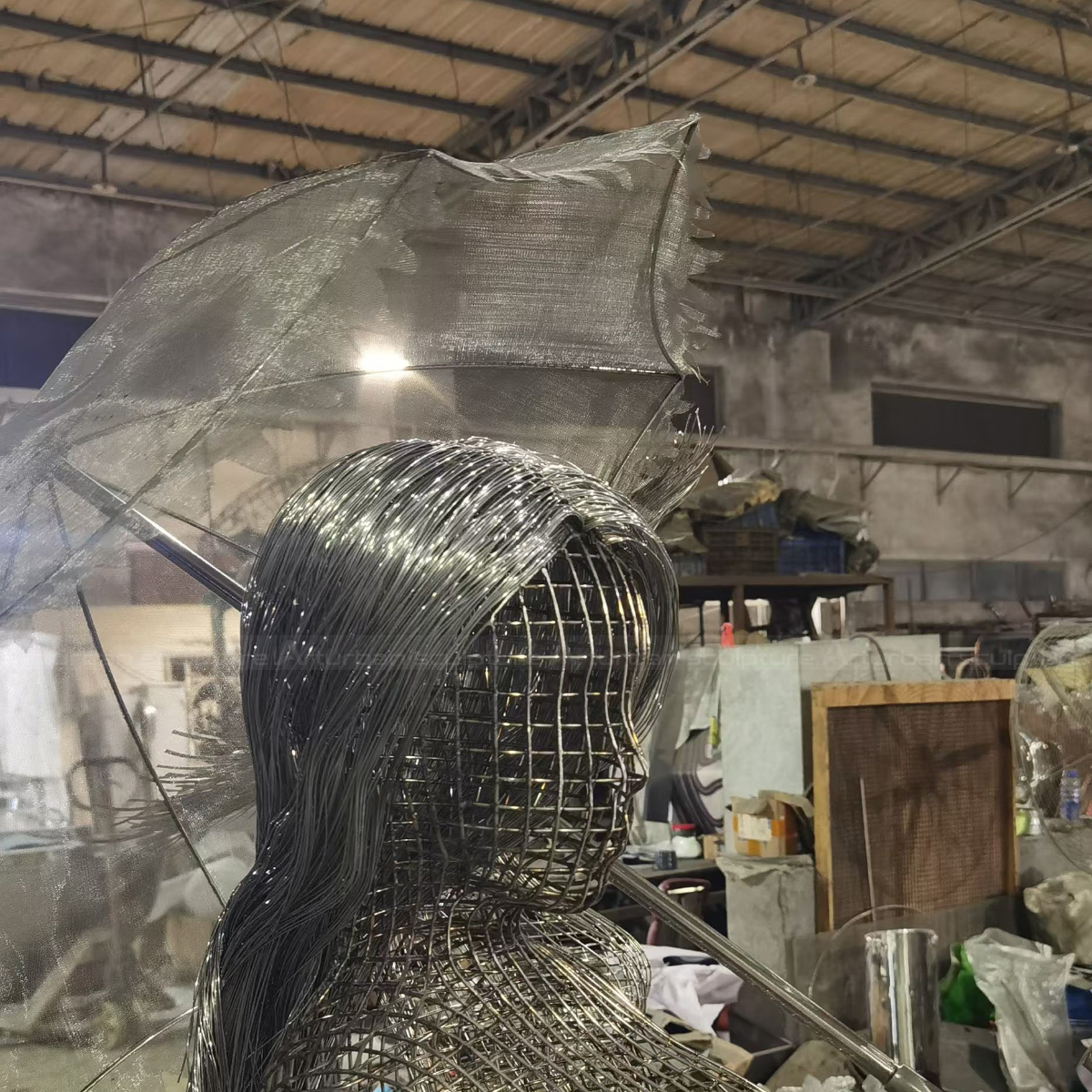 Close-up of Figurative woman Wire Sculpture with holding an umbrella
