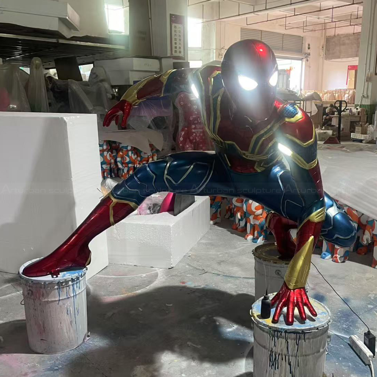Spider Man Advanced Suit Statue crouching with detailed red and blue suit and glowing eyes