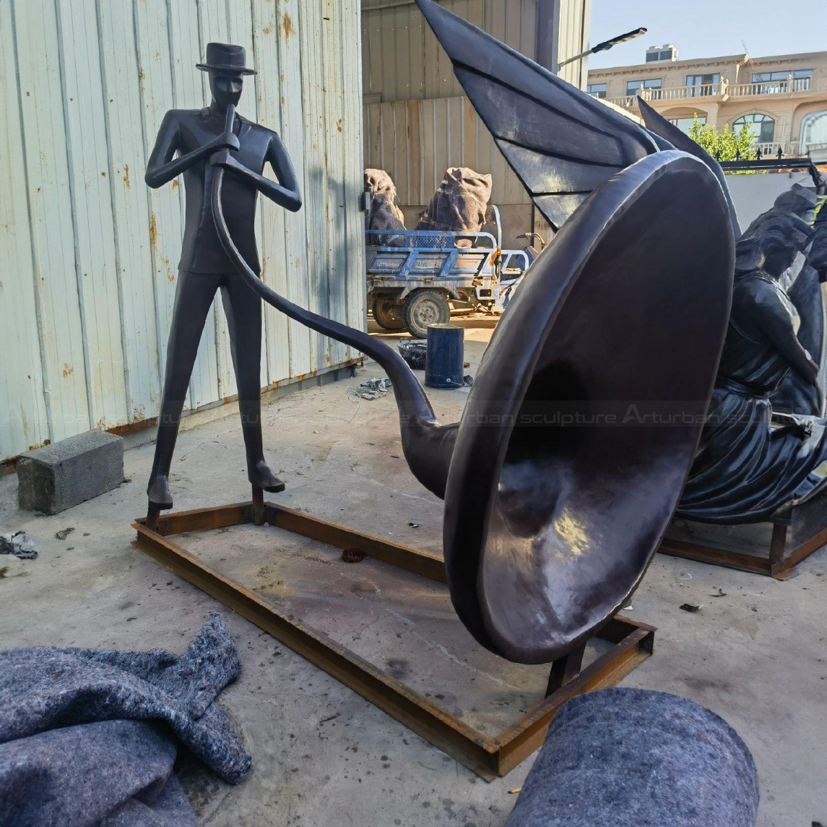 abstract male Musician playing a large horn Art Sculpture