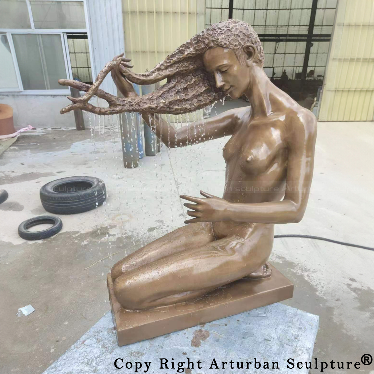 nude woman washing hair water feature by Malgorzata Chodakowska