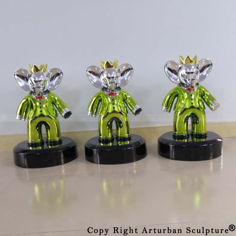 Frontal view of a Babolex culpture with a green tuxedo and silver face