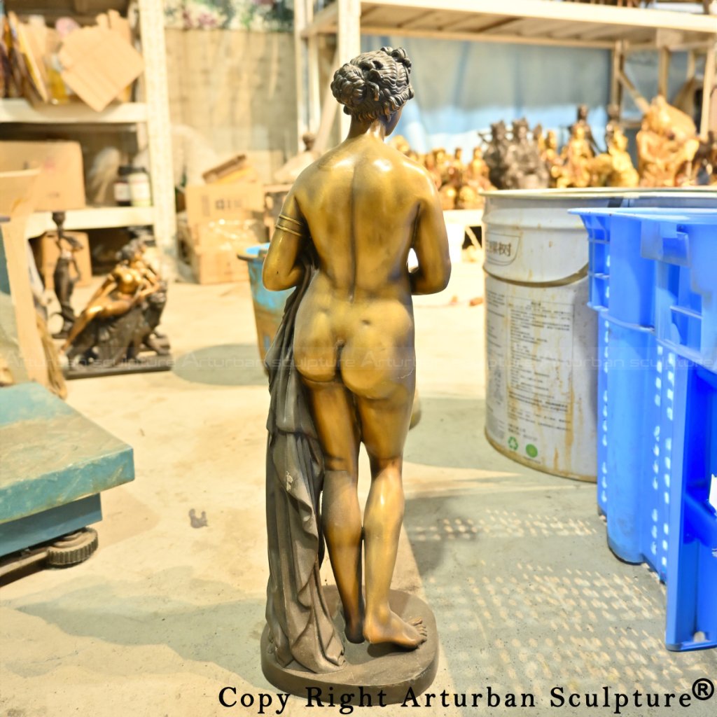 Back view of a bronze Venus sculpture holding a draped cloth, with detailed hair