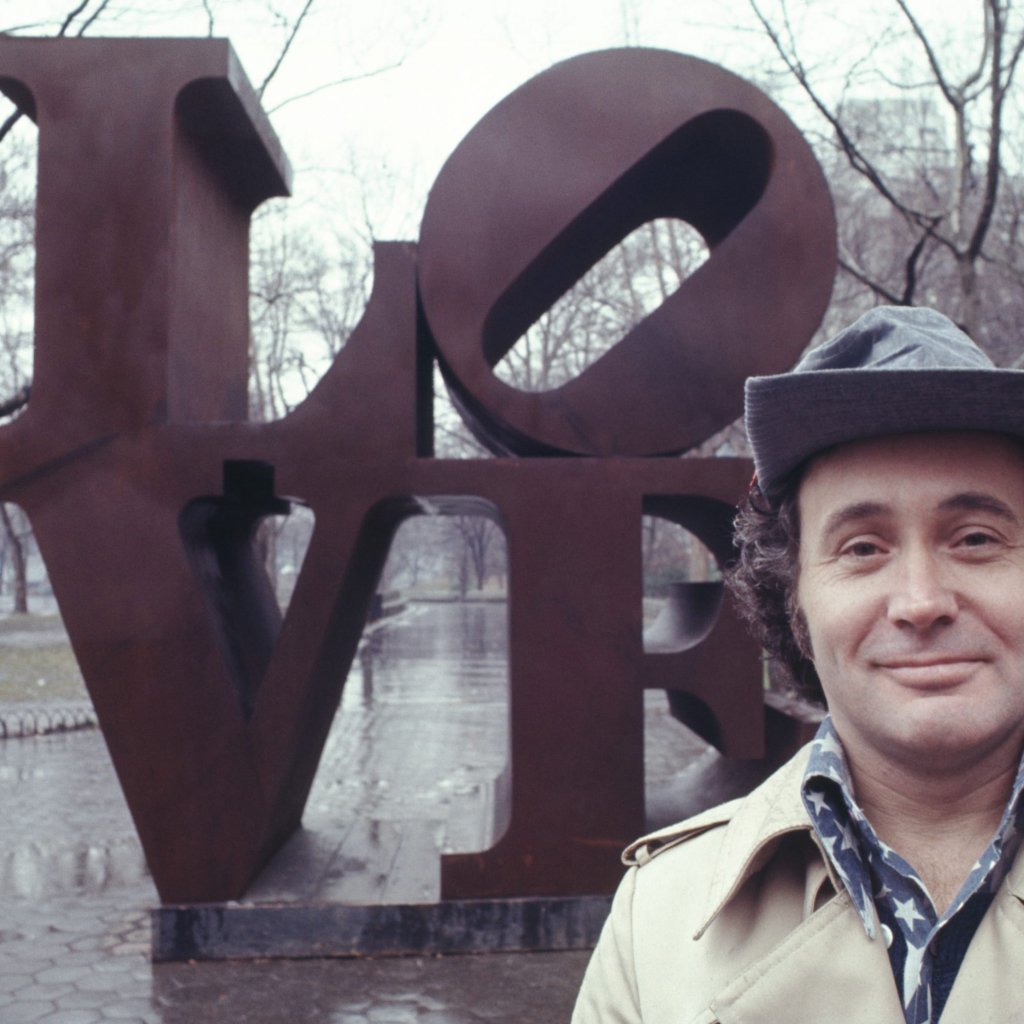 robert indiana standing in front of love sculpture