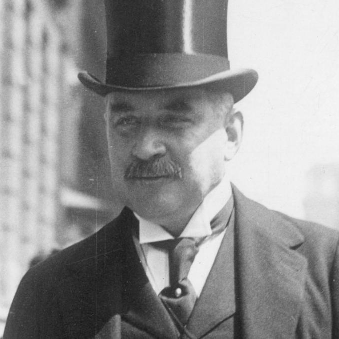 J.P. Morgan wearing a top hat and suit, early 20th-century portrait.