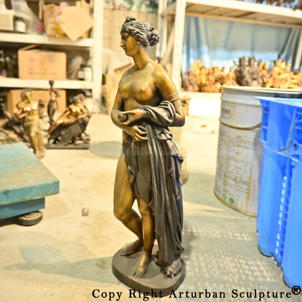Side view of bronze Venus with the apple in her left hand
