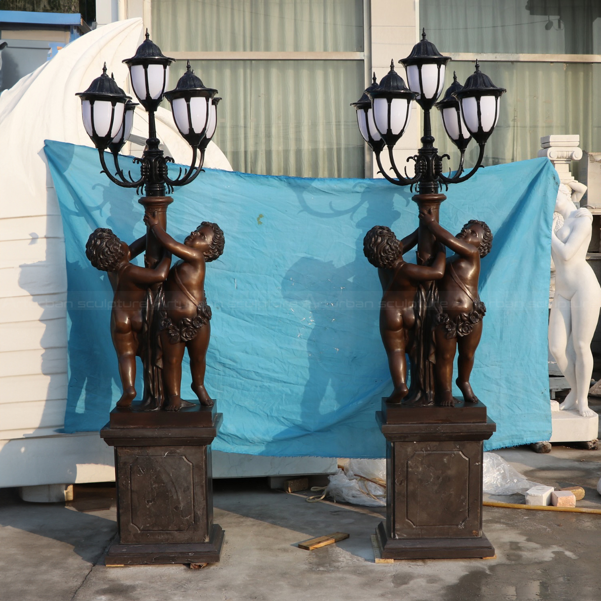A pair of Antique Cherub Floor Lamp statues