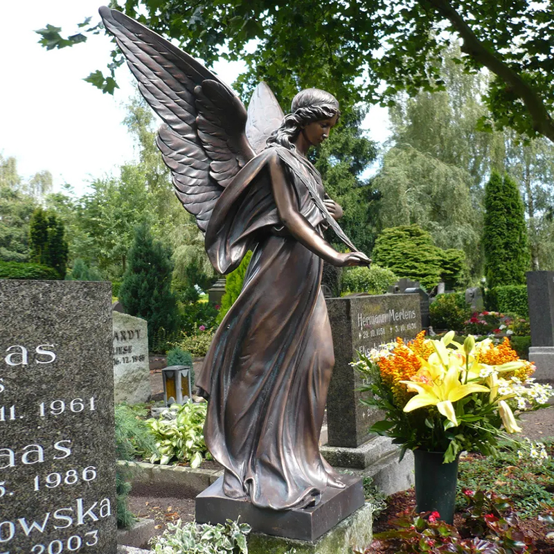 Angel holding a palm frond statue for memorial or cemetery