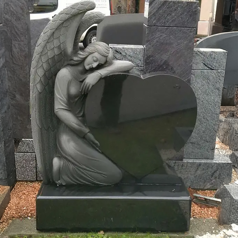 Angel kneeling and leaning on heart-shaped granite Monument Headstone