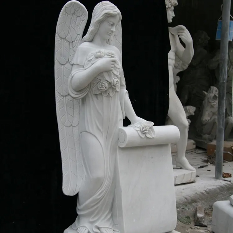 Cemetery Angel Headstones for Sale standing beside a large scroll