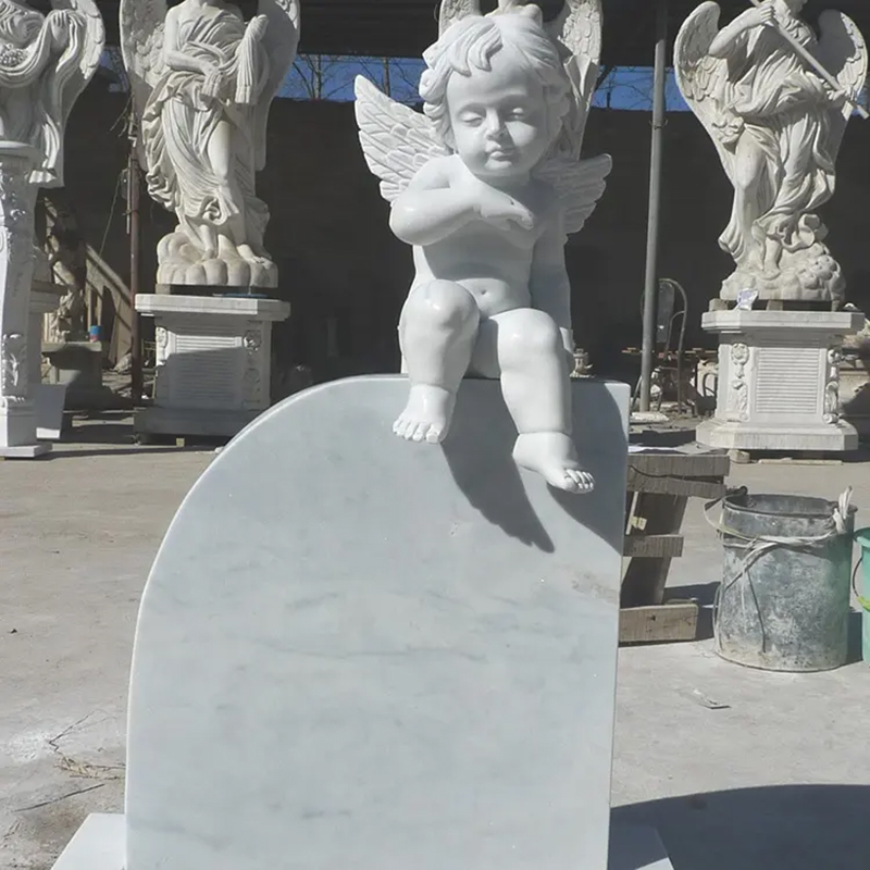 Cherub sitting on the top of Gravestone