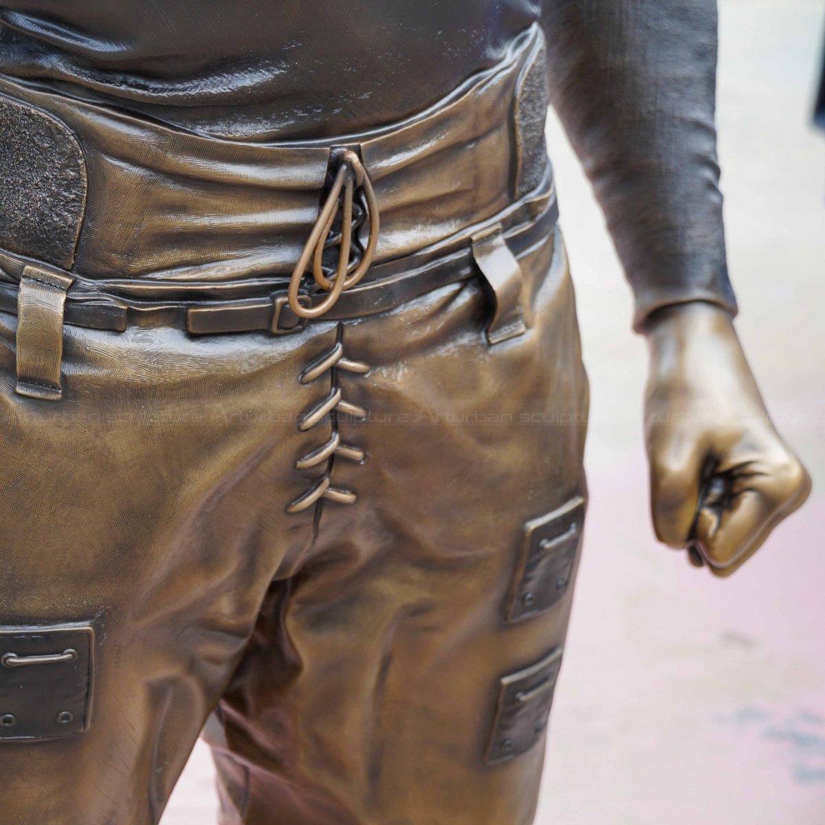 Close-up of the bronze Duke Slater Statue's pants detail