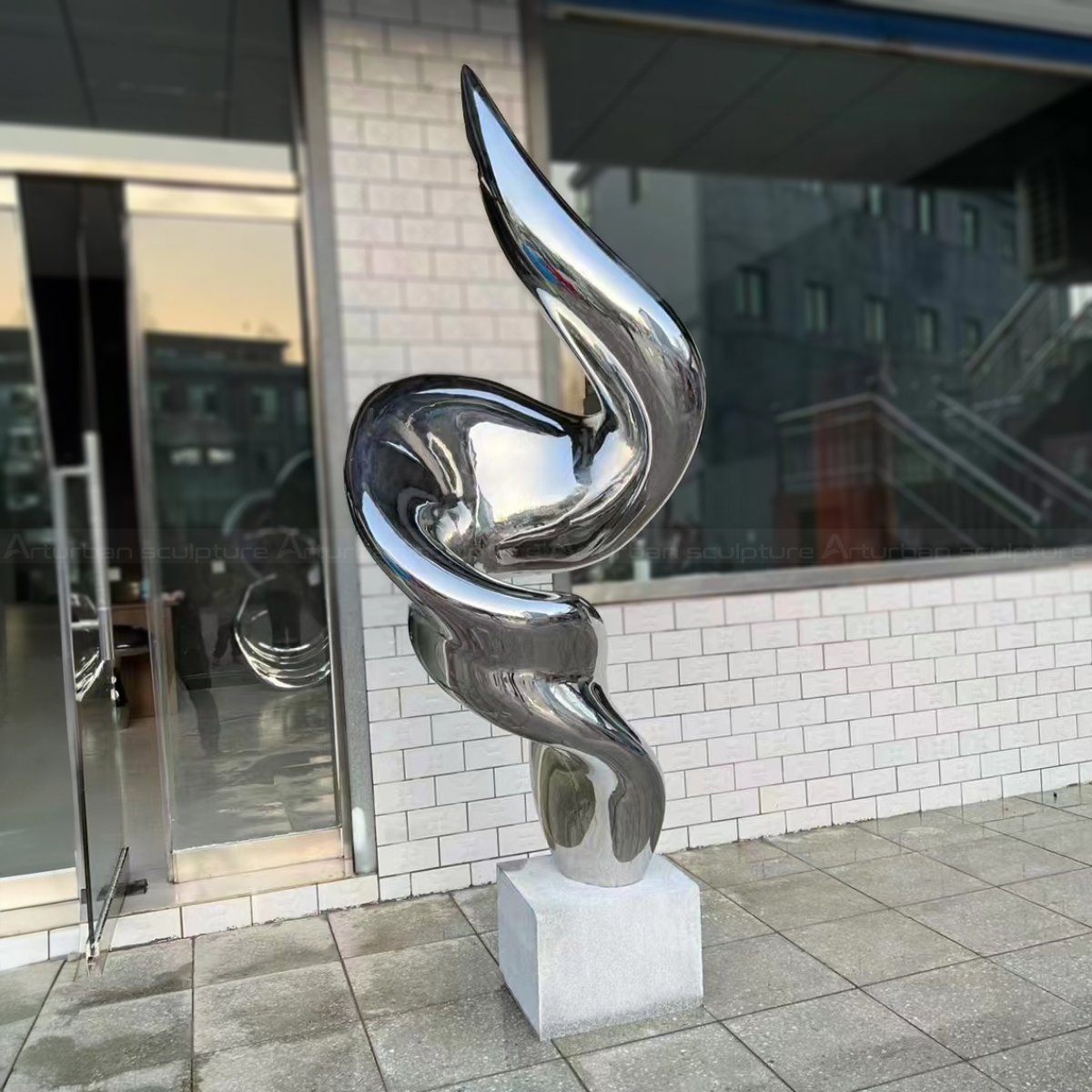 Garden Modern stainless steel Statues featuring a smooth, reflective spiral design
