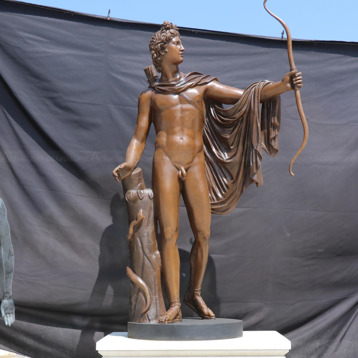 Greek Male Nude Statues showing Apollo holding a bow and wearing a draped cloak