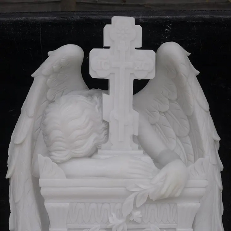 Grieving Angel Headstone showing the angel with its head resting on the cross