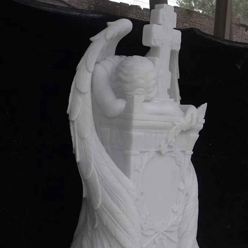 Grieving Angel leaning on marble Headstone