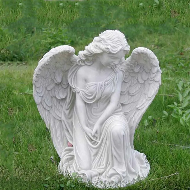 Kneeling Angel Figurine looking down in a thoughtful expression