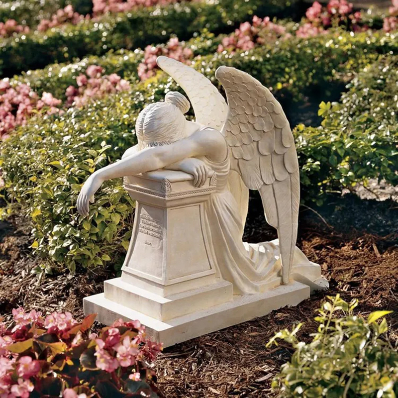 Marble Angel of Grief Monument sculpture with the angel kneeling by a tombstone, head bowed in sorrow
