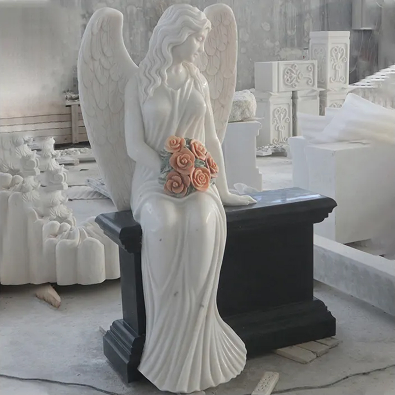 Marble Angel sitting on Headstone holding a bunch of roses