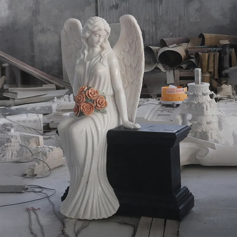 Marble Angel sitting on Headstone with flower