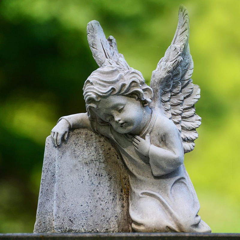Marble Cemetery Cherub Statue with delicate wings and a sorrowful expression