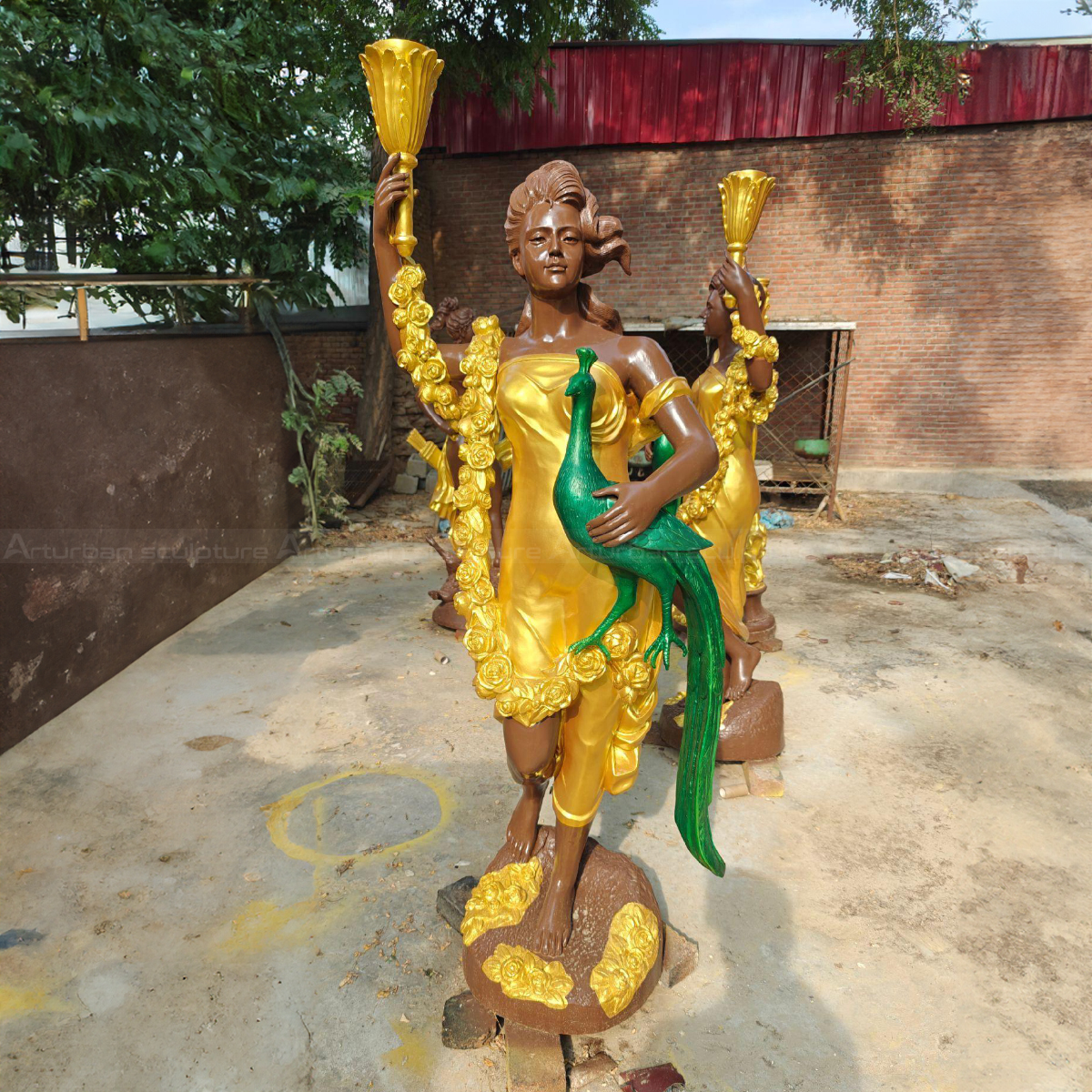 Outdoor Goddess Statue showing hera holding peacock and torch