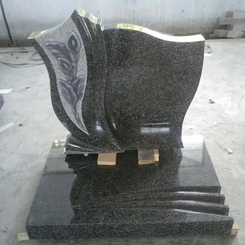 Polished dark gray granite Headstone with a carved calla lily flower design on the side