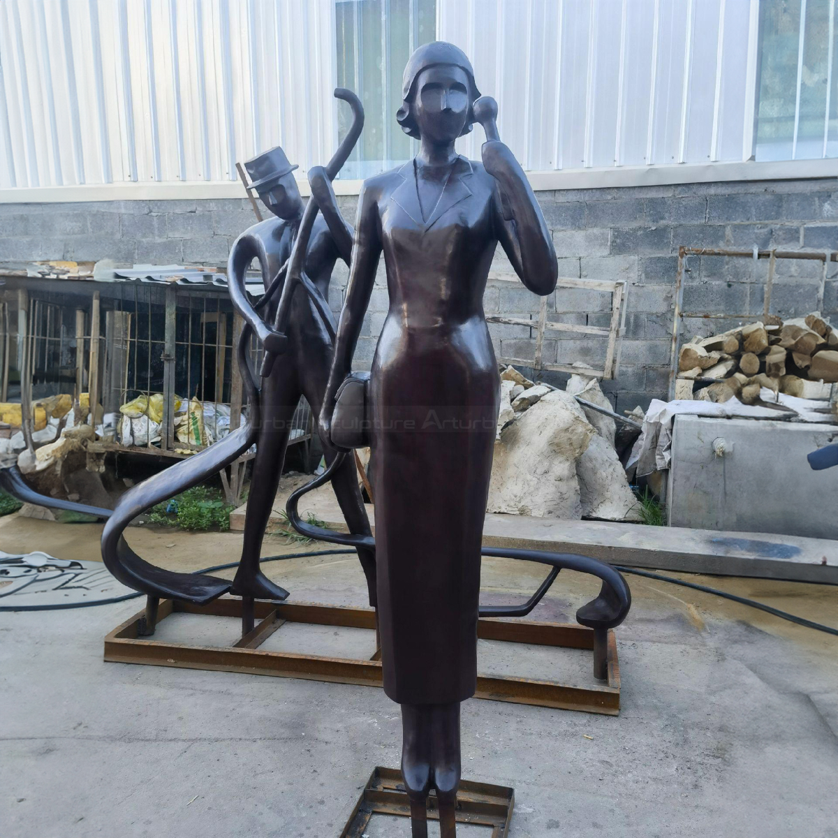 Semi Abstract Sculpture showing a lady holding a phone