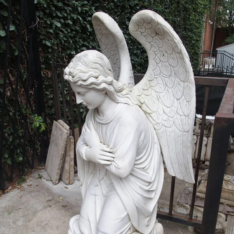Side view of Cemetery Angel kneeling and mouring Sculpture
