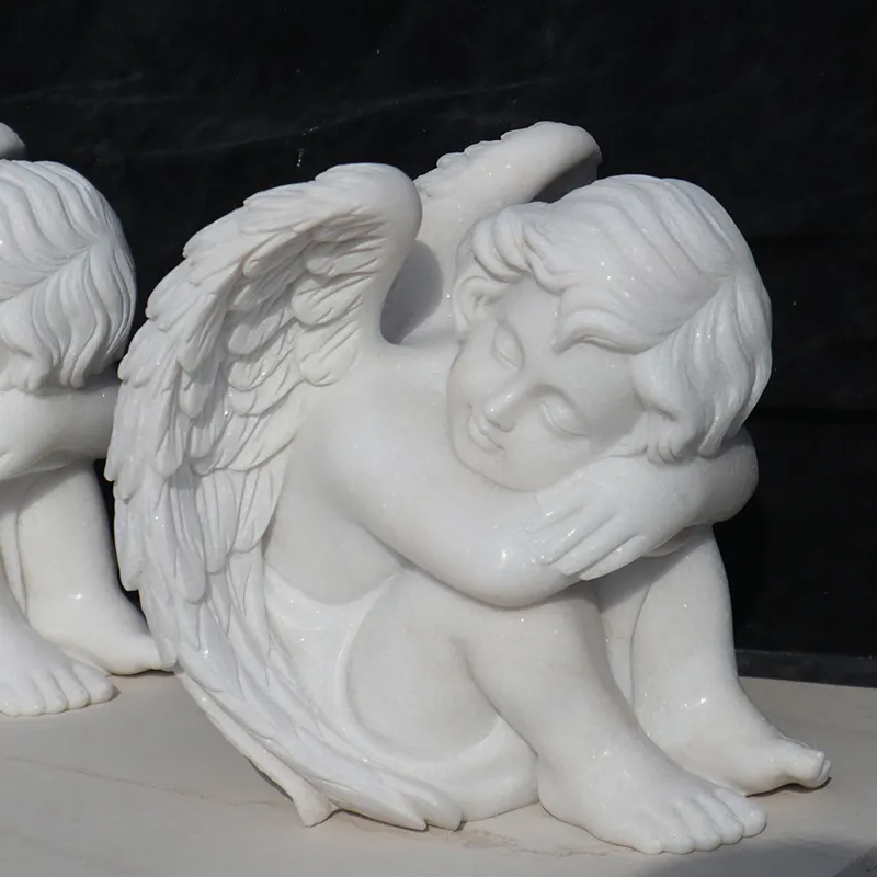 Sleeping Cherub Angel showing little angel with his head resting on his knees with his wings softly resting behing him