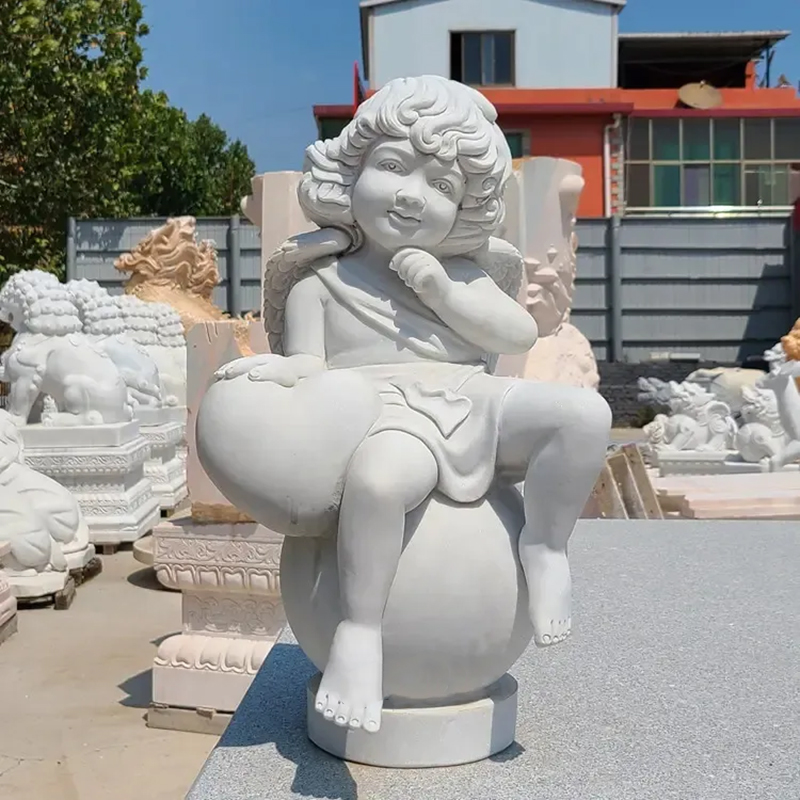 Stone Cherub sitting on ball Garden Statue with heart-shape stone
