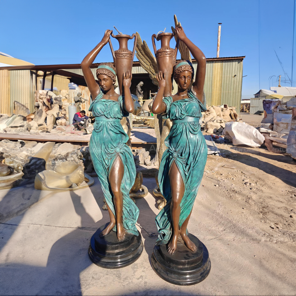 a pair of Woman with Vase Statues