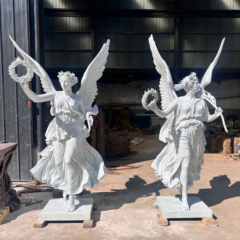 a pair of white marble Angel of Victory Statue holding wreath