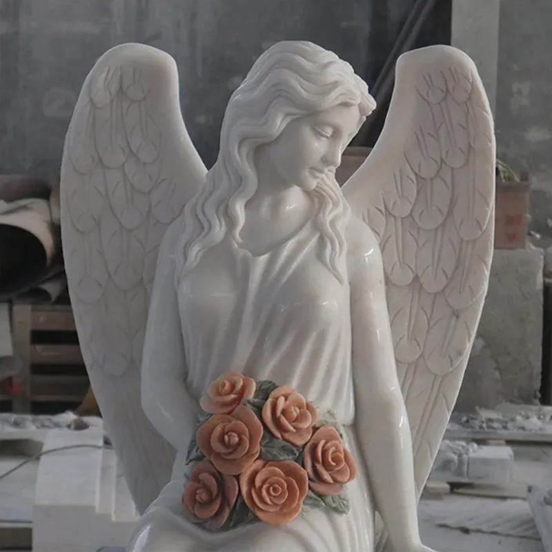 close up of Marble Angel statue holding a bunch of roses