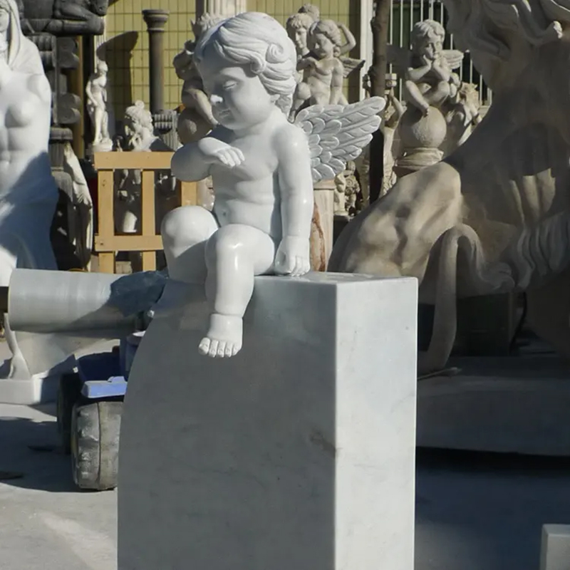 little Cherub sitting on top of Gravestone