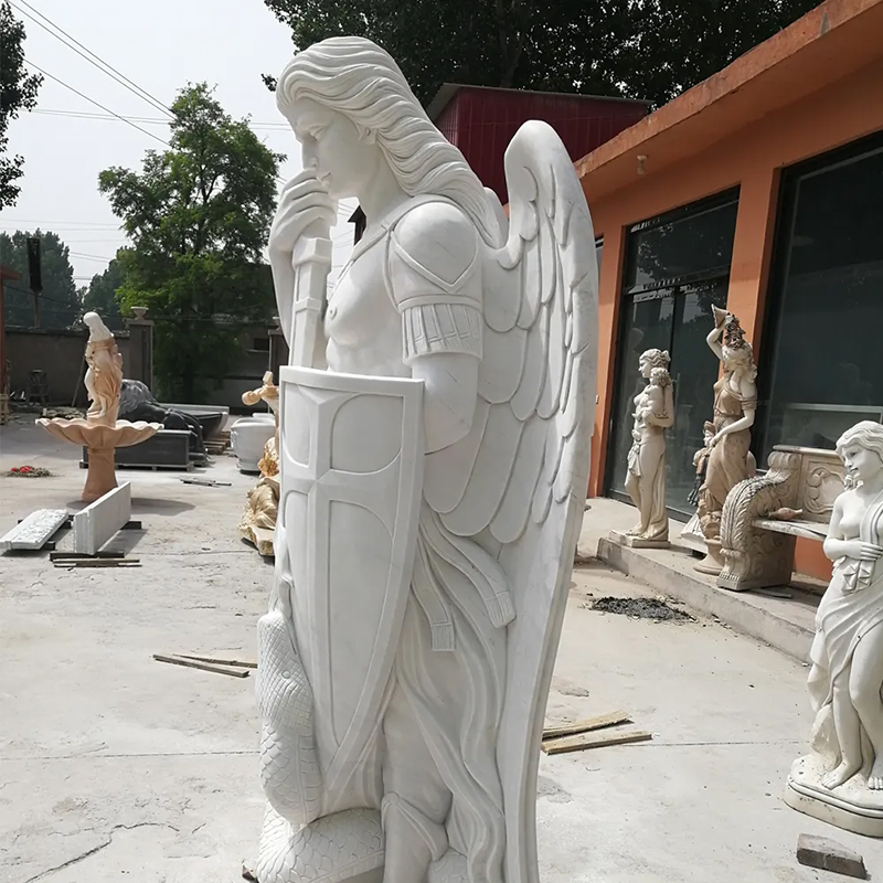 side view of white marble Outdoor Statue of St Michael holding shield
