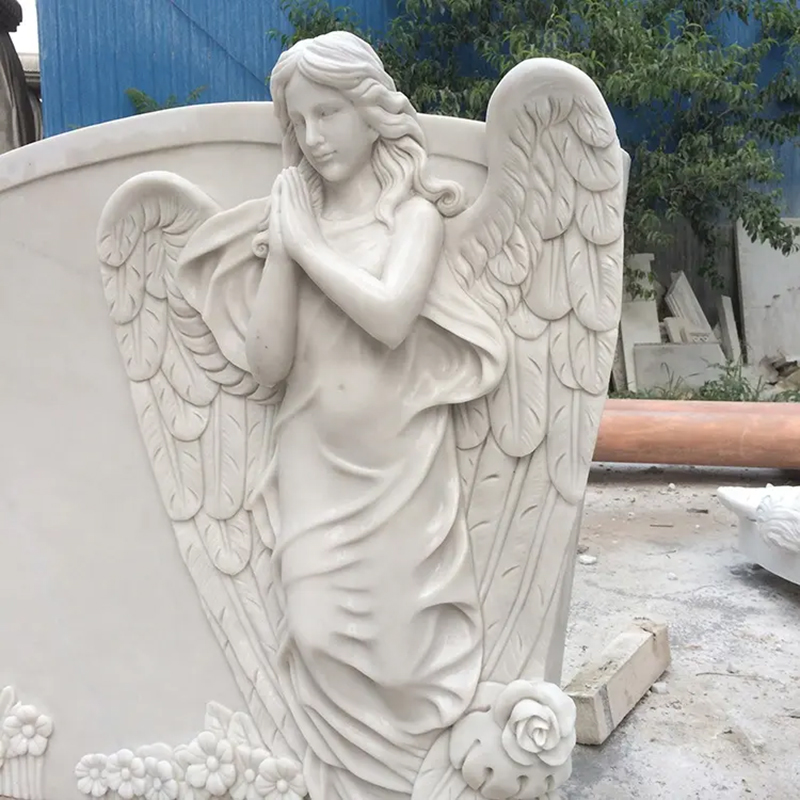 white marbel Headstones with praying Angels on Them