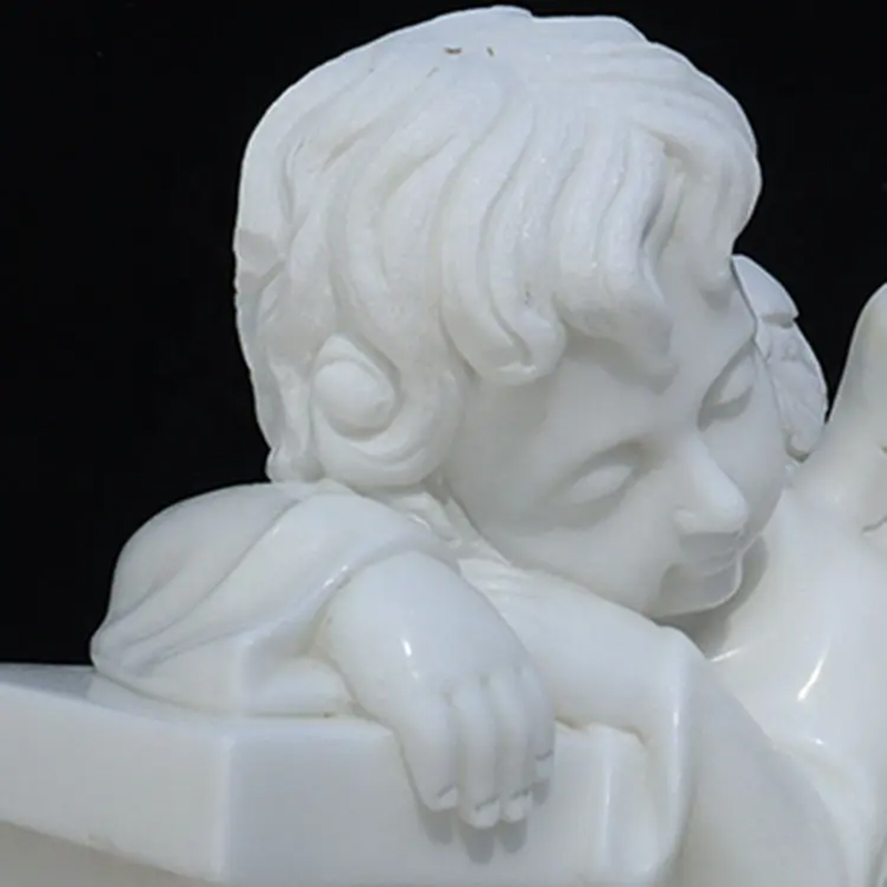 white marble Sleeping Cherub Statue with its head resting on its hands