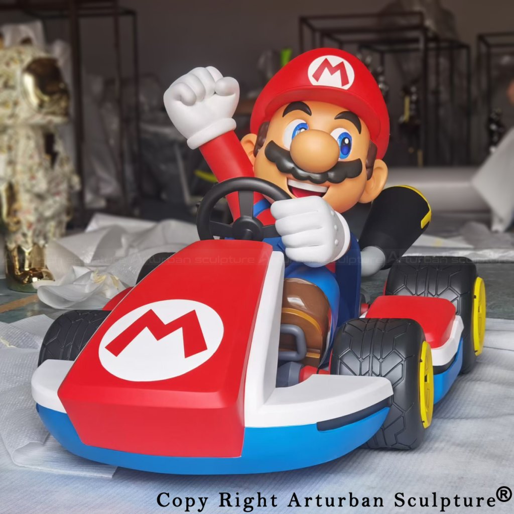Mario Kart fiberglass statue, highlighting Mario's expressive face, raised arm, and the vibrant design of the kart.
