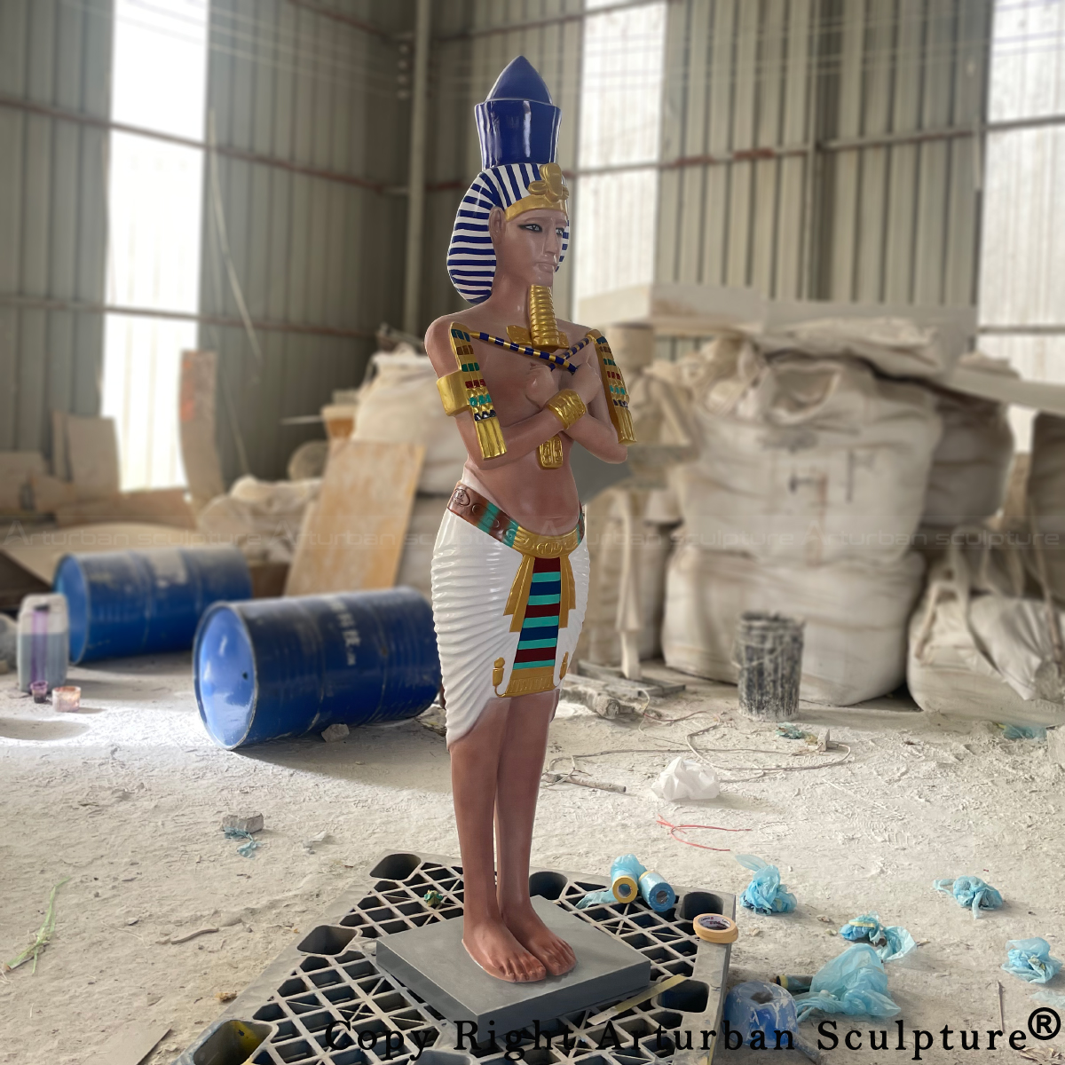 life size fiberglass pharaoh sculpture holding two flails across the chest